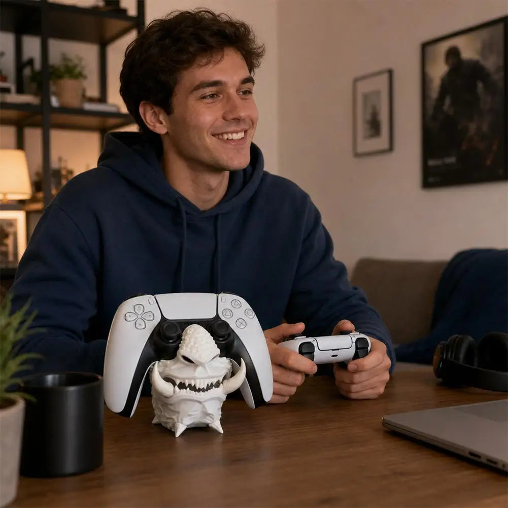 Bone-white 3D-printed oni mask desk stand holding a white PS5 DualSense controller, front view